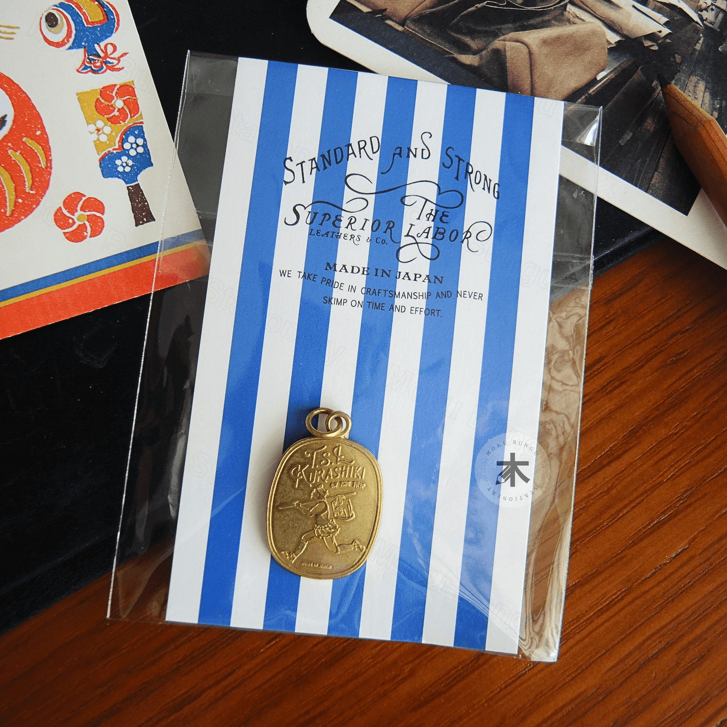 The Superior Labor - Brass Charm - TSL Courier